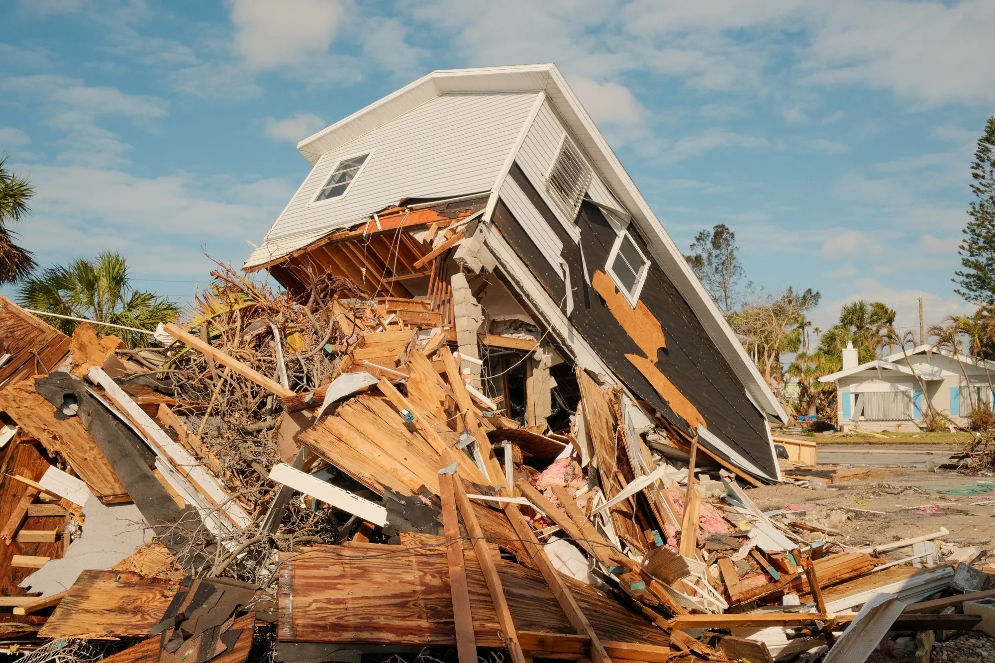 Severely damaged home collapsed after powerful hurricane winds.